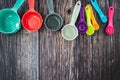 Set of colorful measuring cups and measuring spoons use in cooking lay on wood tabletop in top view Royalty Free Stock Photo
