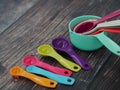 Set of colorful measuring cups and measuring spoons use in cooking lay on wood tabletop in top view Royalty Free Stock Photo