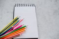 Set of colorful pencils on abstract spiral notepad with white sheets Royalty Free Stock Photo