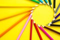 Set of colorful pencils on a yellow background is laid out in a circle in the shape of the sun. Copyspace, frame. Back to school, Royalty Free Stock Photo