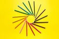 Set of colorful pencils on a yellow background is laid out in a circle in the shape of the sun. Copyspace, frame. Back to school, Royalty Free Stock Photo