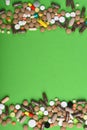 Set of colorful pills scattered on green background Royalty Free Stock Photo