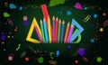 Set of colorful school supplies isolated on abstract green chalkboard background with paint splashes. Royalty Free Stock Photo