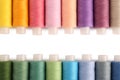 Set of colorful sewing threads on white background, flat lay. Space for text Royalty Free Stock Photo