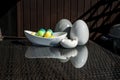 Set colorful shiny Easter eggs and grey and white colored ceramic and reflection on table