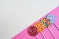 Set of colorful spiral lollipops on colored paper