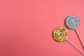 Set of colorful spiral lollipops on coral colored paper