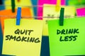 A set of colorful sticky notes with positive affirmation words and phrases hung from a clothesline by clothespins.