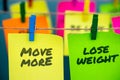 A set of colorful sticky notes with positive affirmation words and phrases hung from a clothesline by clothespins.