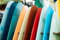 Set of colorful surfboard for rent on the beach. Multicolored blue, red, white surf boards different sizes and colors surfing Royalty Free Stock Photo