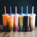 Set of colorful tall drinking glasses with straws with Taiwanese bubble or boba tea from vegan milk and agava sypur with different