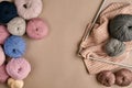 Set of colorful wool yarn and knitting on knitting needles on beige background. Top view Royalty Free Stock Photo