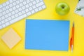 Set of colourful stickers, white keyboard, notebook and snacks.