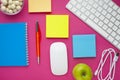 Set of colourful stickers, white keyboard, notebook and snacks.