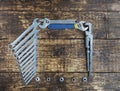 Set of combination wrenches and old adjustable wrenches on an old wooden background Royalty Free Stock Photo