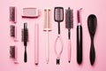 Set of combs and brushes on pink background, top view. Beauty salon, Professional hairdresser doing hairstyle for women in beauty