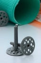 A set of construction items for the insulation of walls. Plastic dowels, a roll of mesh for the insulation of facades and a corne Royalty Free Stock Photo