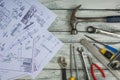 Set of construction tools and blueprints on the white,rustic wooden background Royalty Free Stock Photo