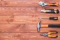 Set of construction tools on a brown wooden background. Hammer, wrench, pliers and screwdriver. Frame for the holiday Labor Day, Royalty Free Stock Photo