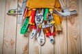 Set of construction tools in toolbelt on wood boards close up Royalty Free Stock Photo