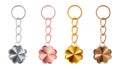 A set of copper, bronze, gold or brass, silver or steel, pink gold keychains in the shape of a flower. Realistic vector.