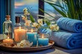 A set of cosmetic accessories for spa rituals, including blue towels, bottles of massage oil and a dried chamomile Royalty Free Stock Photo