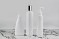 Set of cosmetic bottles, collection empty white bottles of cream with dispenser, shampoo or lotion on white background