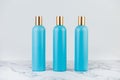 Set of cosmetic bottles, collection of three empty blue bottles of shampoo or lotion on white background Royalty Free Stock Photo