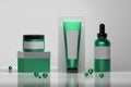 Set of cosmetic bottles in green colors with shiny beads.