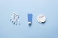 Set of cosmetic products on blue color background. Cotton pads, cotton sticks, bottle, makeup remover, micellar water, wash gel. Royalty Free Stock Photo