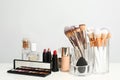 Set of cosmetic products and makeup brushes on table Royalty Free Stock Photo