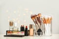 Set of cosmetic products and makeup brushes on table Royalty Free Stock Photo