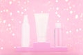 Three beauty products on pink winner pedestal against pink background with bokeh. Concept of gifts and holidays