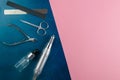 A set of cosmetic tools for manicure and pedicure. Manicure scissors, cuticles, saws, miller stand on a blue and pink background.