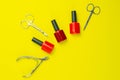 A set of cosmetic tools for manicure and pedicure. Manicure scissors, cuticles, saws, miller stand on a yallow background. Top