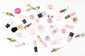 Set of cosmetics on a white background and twigs of flowers. Fla