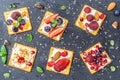 Set of crackers with various fruit close-up on black stone plate Royalty Free Stock Photo