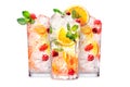 Set of crafted cocktails with berries, a slice of orange, ice cubes and a sprig of mint Royalty Free Stock Photo