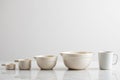 Set of cream colored ceramic measuring cups and bowls Royalty Free Stock Photo