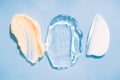 Set of cream and gel smears, various cosmetic products texture. Cream and gel smudges over pastel blue background