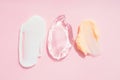 Set of cream and gel smears, various cosmetic products texture. Cream and gel smudges over pastel pink background