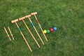 Set of croquet equipment on green grass, above view. Space for text Royalty Free Stock Photo