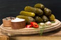 Set of cucumbers next to spices, pepper and salt, on a wooden table Royalty Free Stock Photo