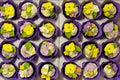 Set of cupcakes in purple wrap in delivery cardboard box. Top view