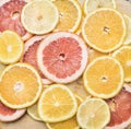 Set of cut citrus fruits lined with lobules on wooden background, top view