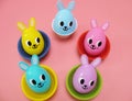 Playful plastic Easter eggs with cute bunny faces