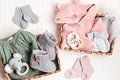 Set of cute organic baby clothes, toys and booties. Heartwarming present for cold weather Royalty Free Stock Photo