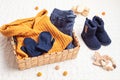 Set of cute organic baby clothes, toys and booties. Heartwarming present for cold weather Royalty Free Stock Photo