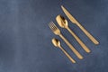 Set of cutlery made of gold metal. Fork, spoon, knife, teaspoon. Royalty Free Stock Photo