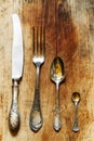 Set of cutlery: spoon, fork, knife in vintage style on old wooden background, top view, selective focus Royalty Free Stock Photo